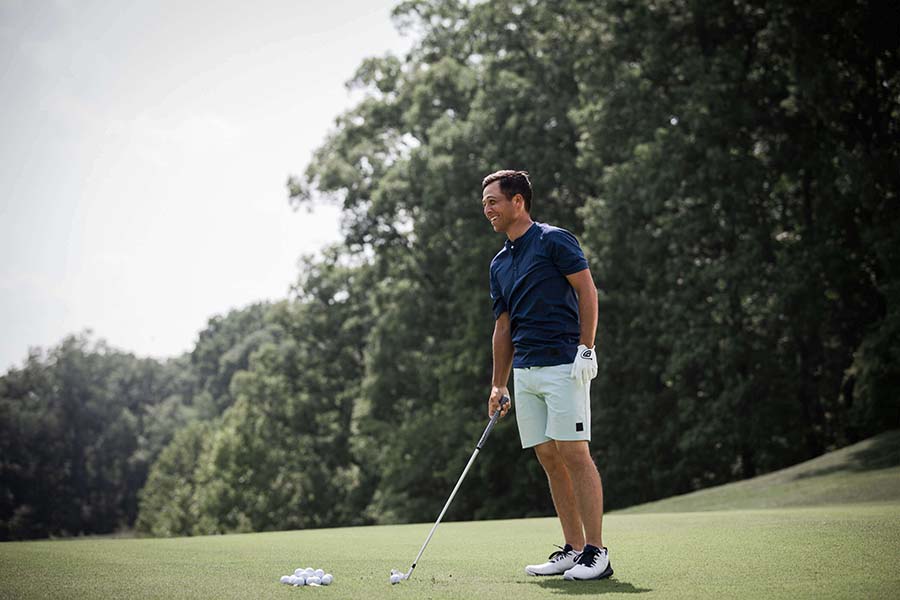 golfer standing on green smiling